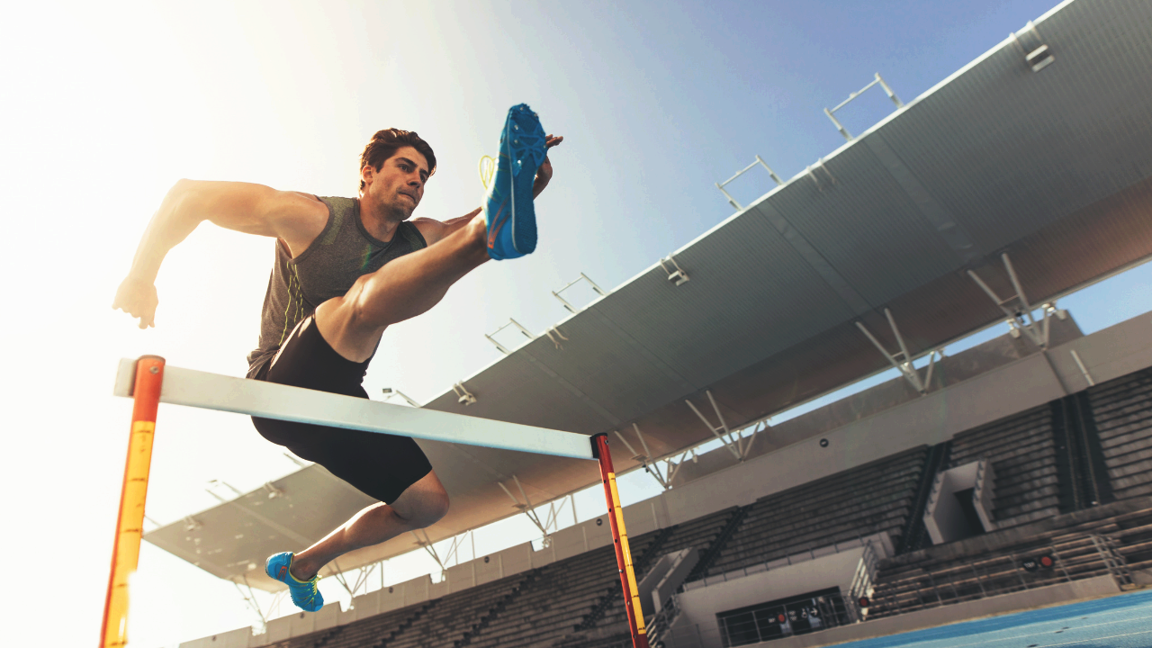 Runner jumping hurdle